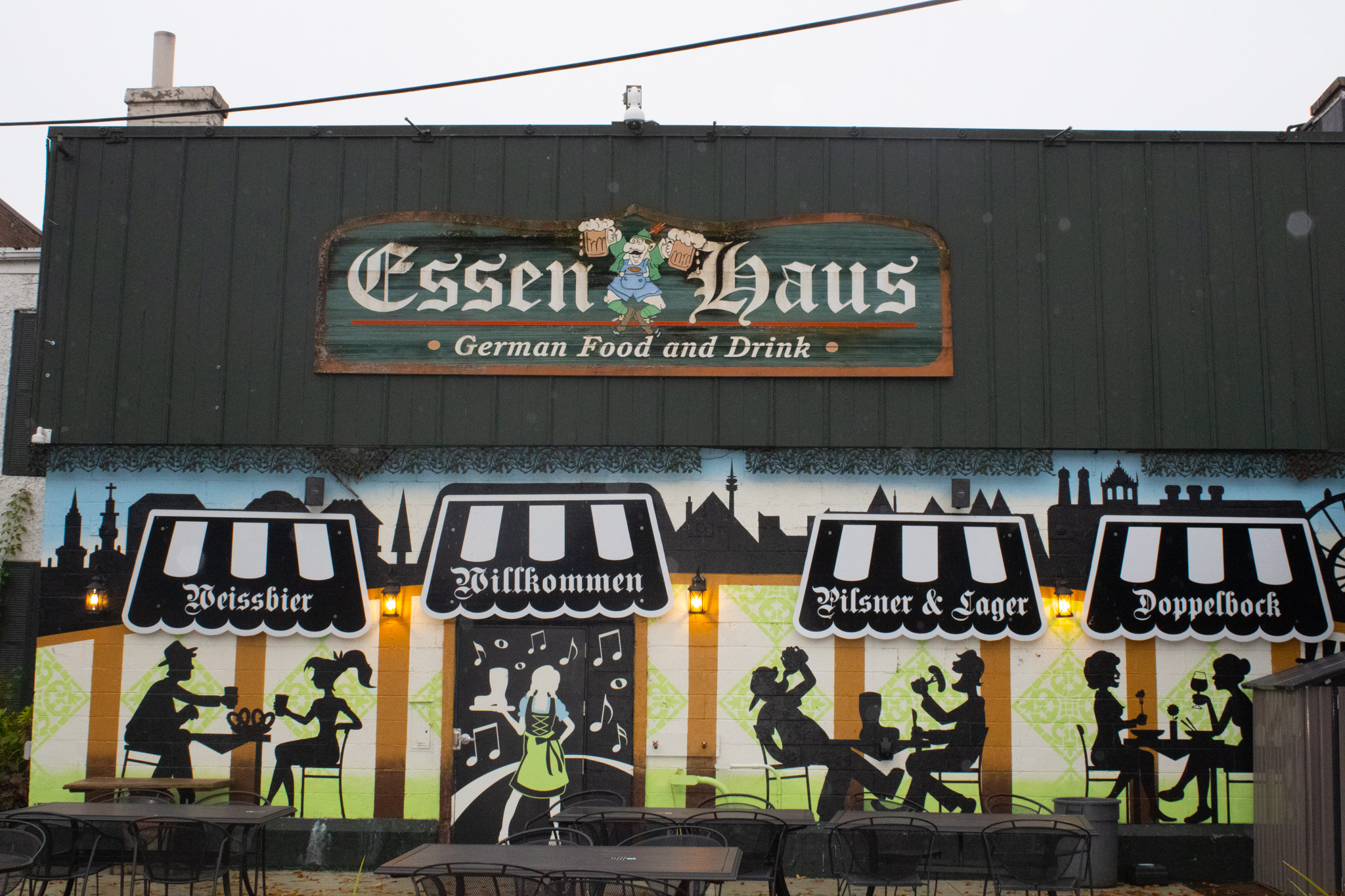 The mural outside of Essen Haus depicts a variety of people drinking, eating and enjoying the atmosphere of the establishment.