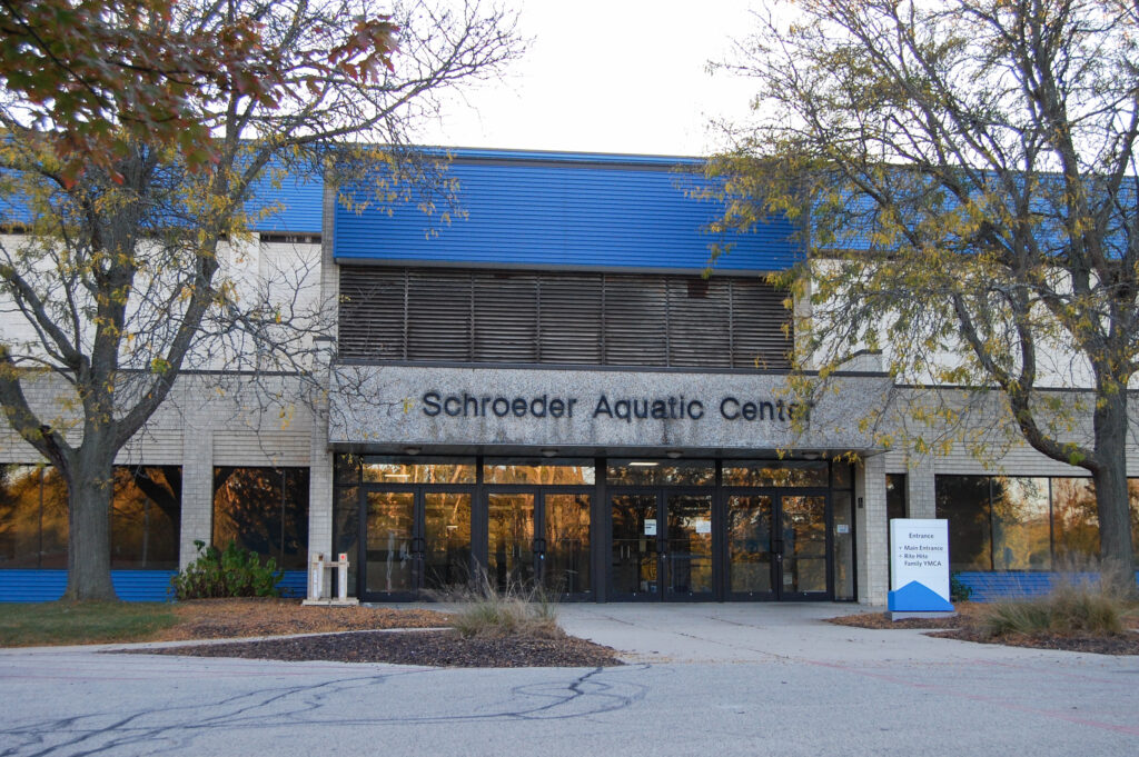 Outside view of the Schroeder Aquatic Center with fall leaves bordering the building. 