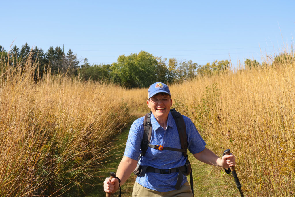 April Scheel smiling in a field. 