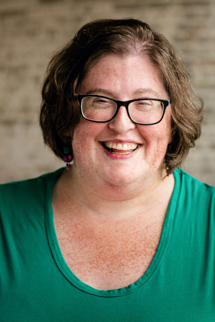 Tasslyn Magnusson wearing a green shirt and smiling. 