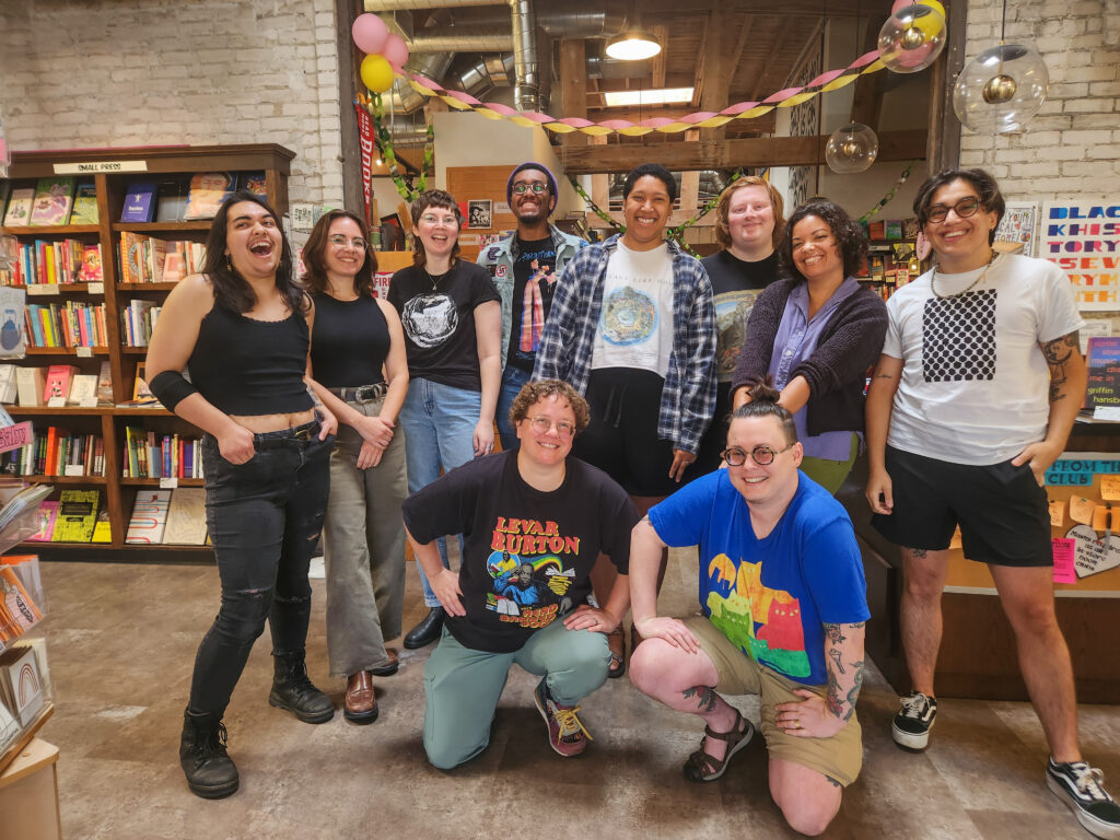 Staff members of the bookstore gathered together smiling. 