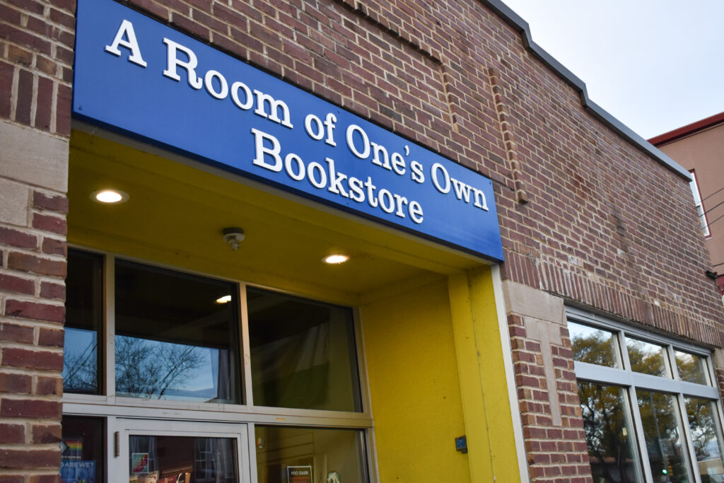 Upward street view of A Room of One’s Own Bookstore. 