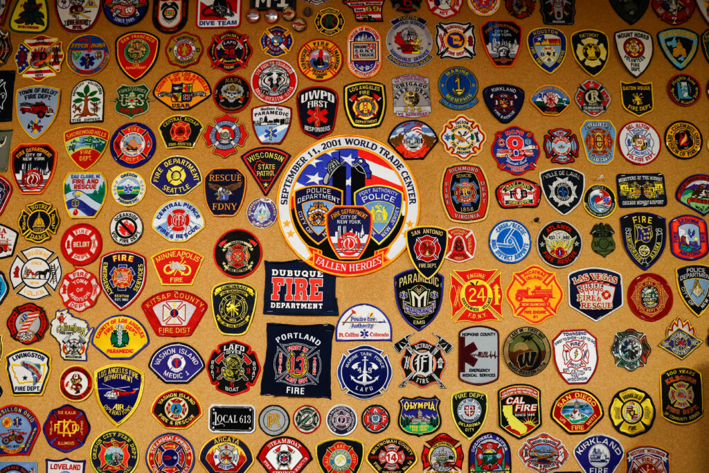 A display of a bunch of patches from fire stations across the United States.