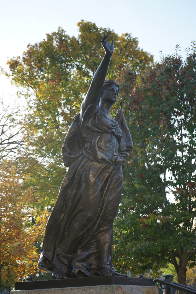 Wisconsin’s Lady Forward in front of various yellow and green leafs. 