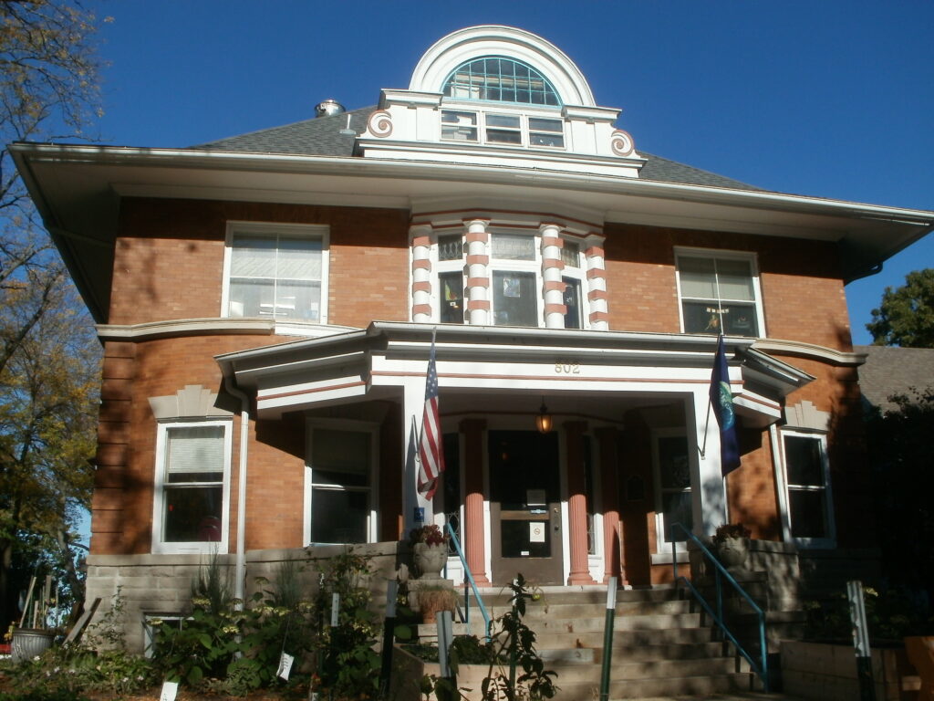 The Yahara House, a brick building with flags on it.