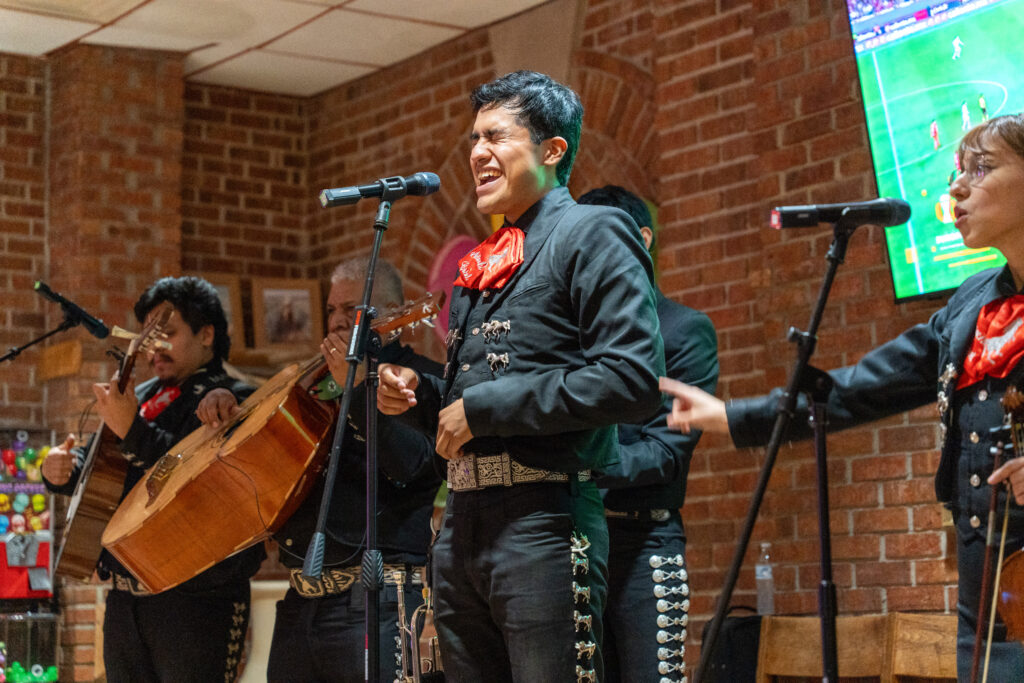 Members of a Mariachi band performing on stage.