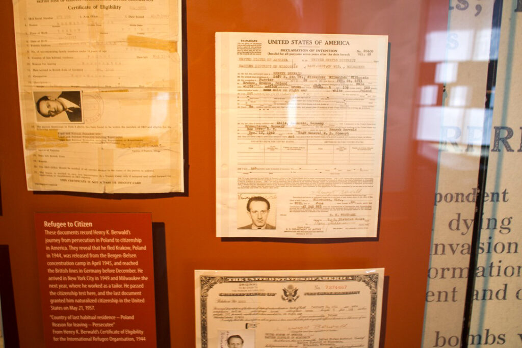 Documents recording Henry K. Berwald's refugee to citizenship status, displayed in a museum.