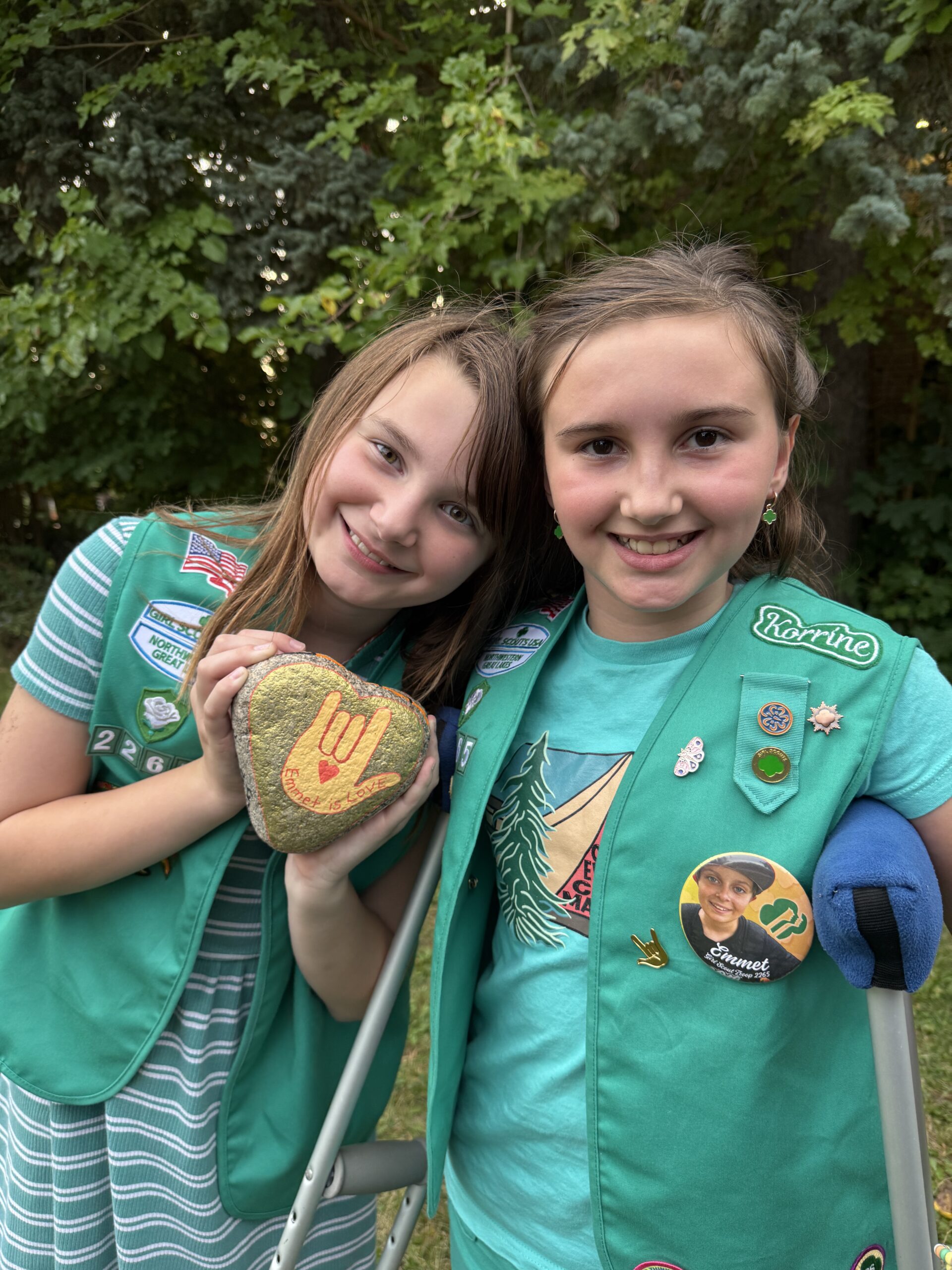 Aurora-jean (left) and Korrine-elliot (right) in green Girl Scouts vests.