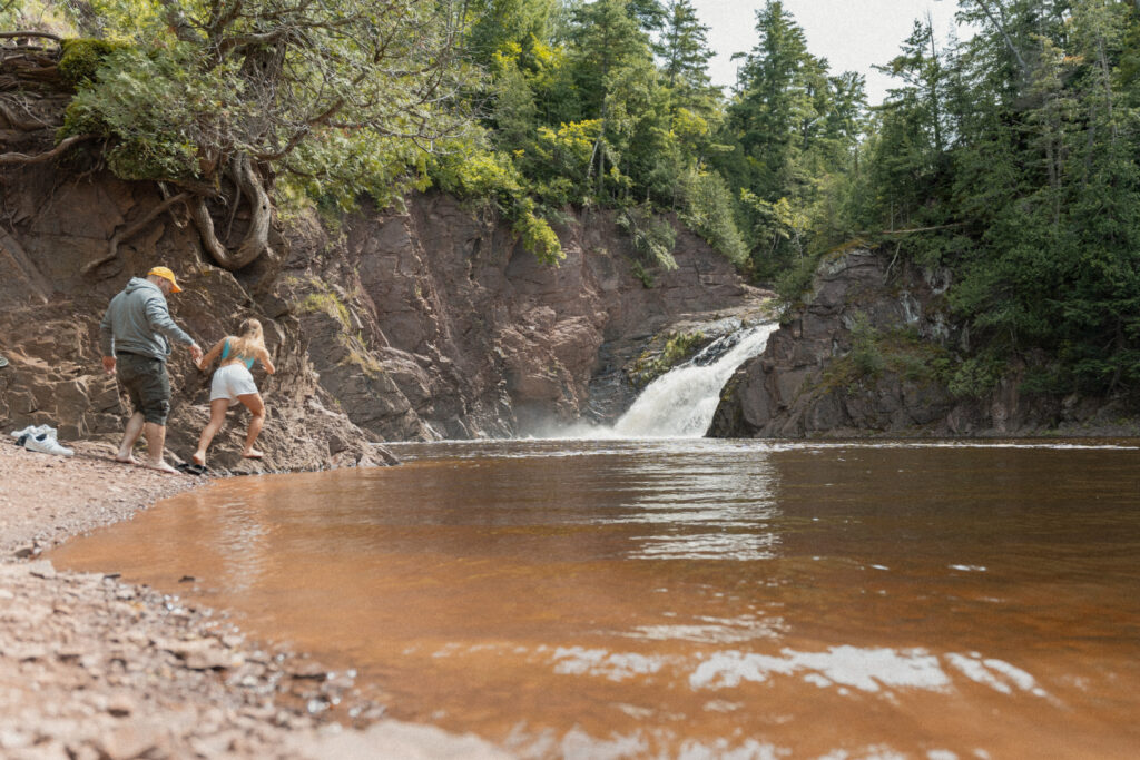 waterfall leads into muddy pond