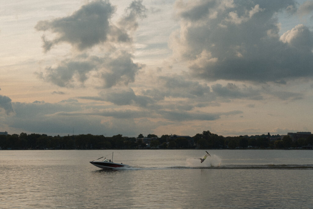 Man does a flip being pulled by a speed boat in the lake