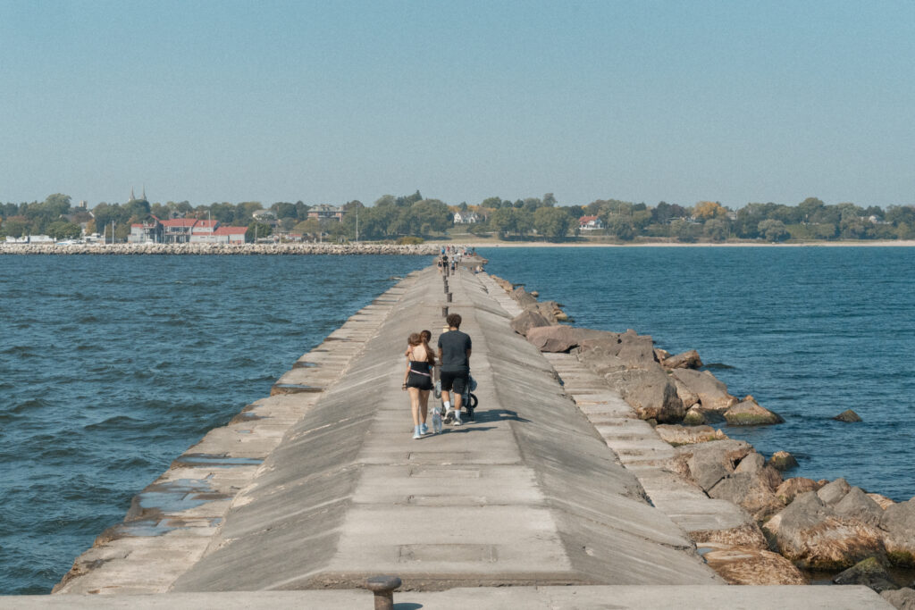 A family walks down a long pier