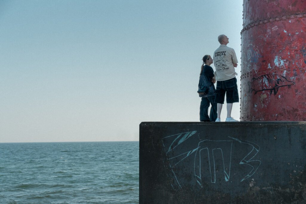 two people look up at the tall structure