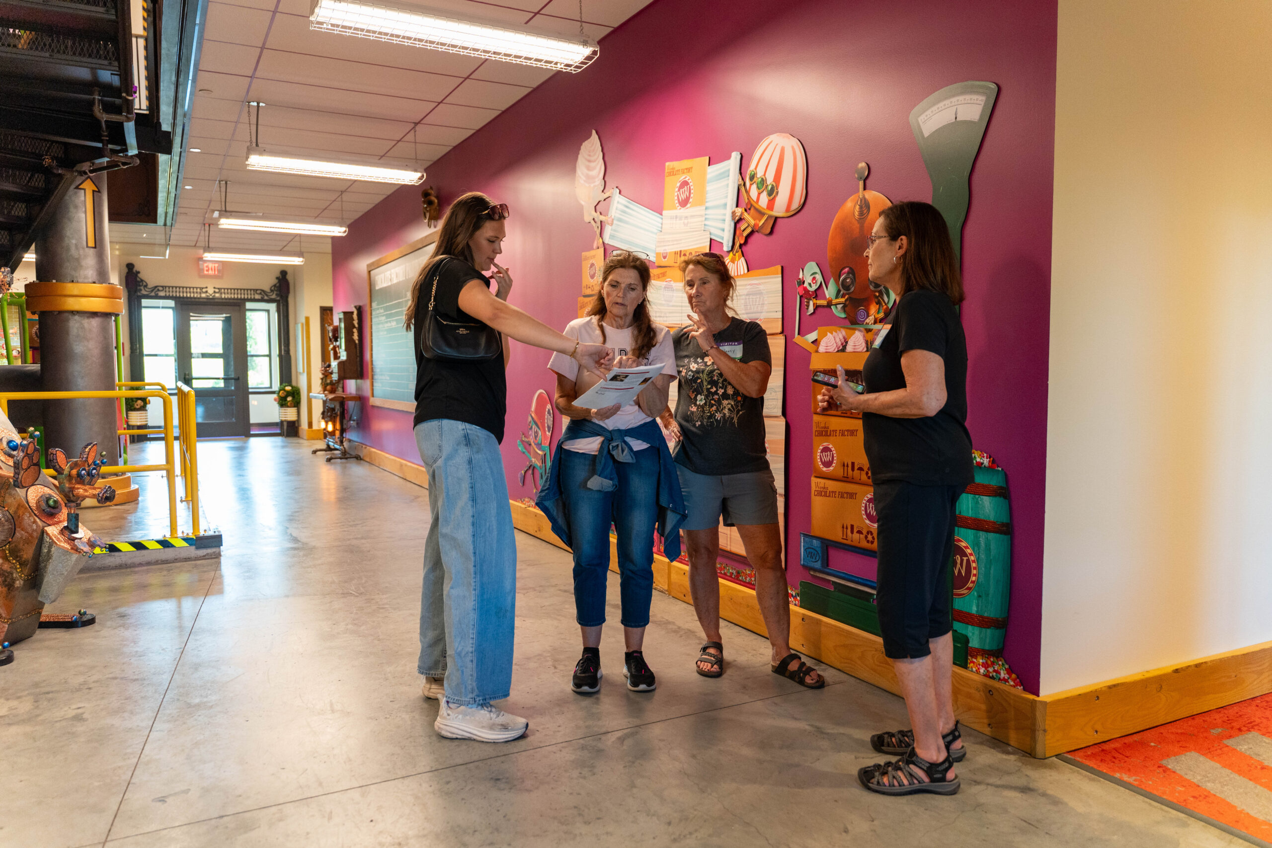 A group of girls are gathered around a map.